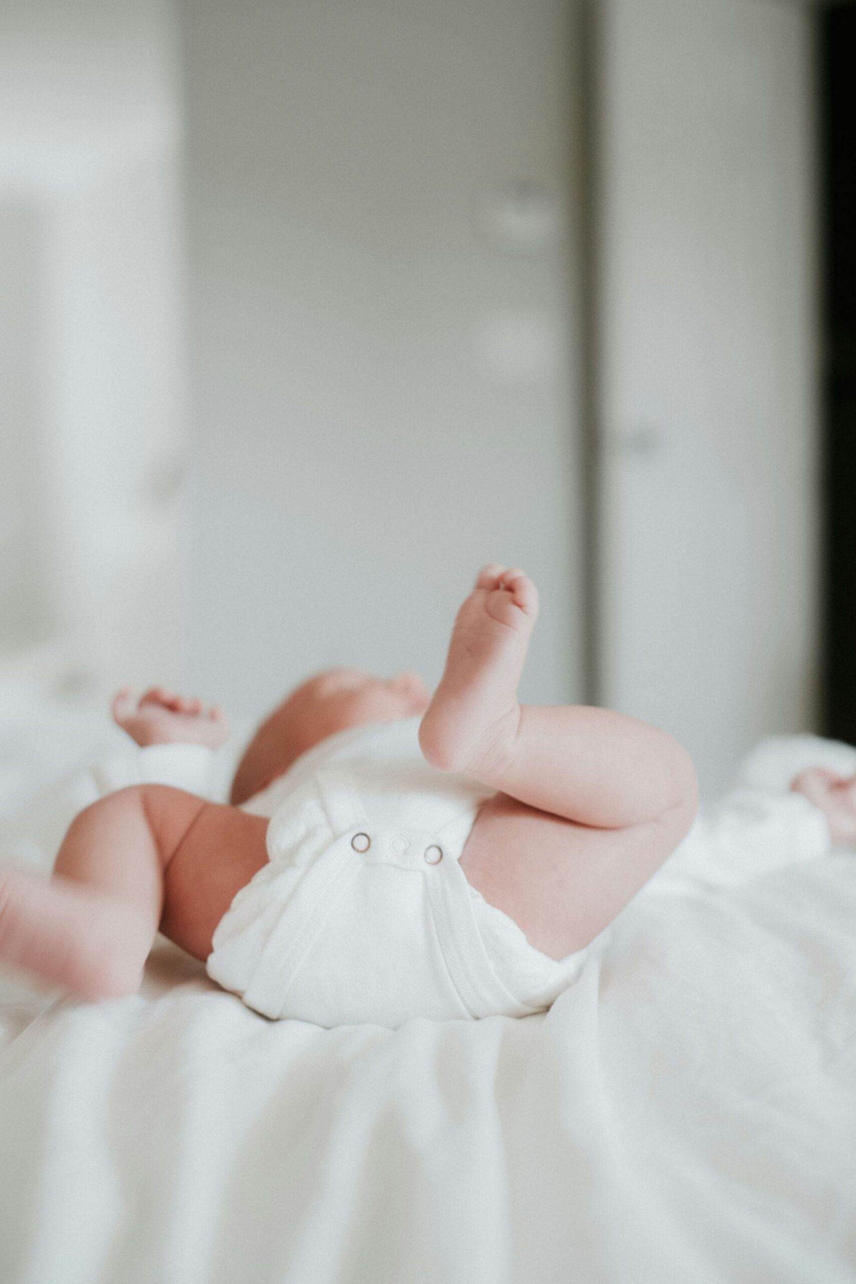 Young infant laying on back